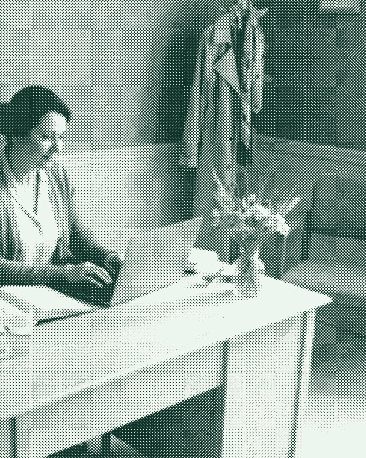 A salon owner at her desk, working through bookings